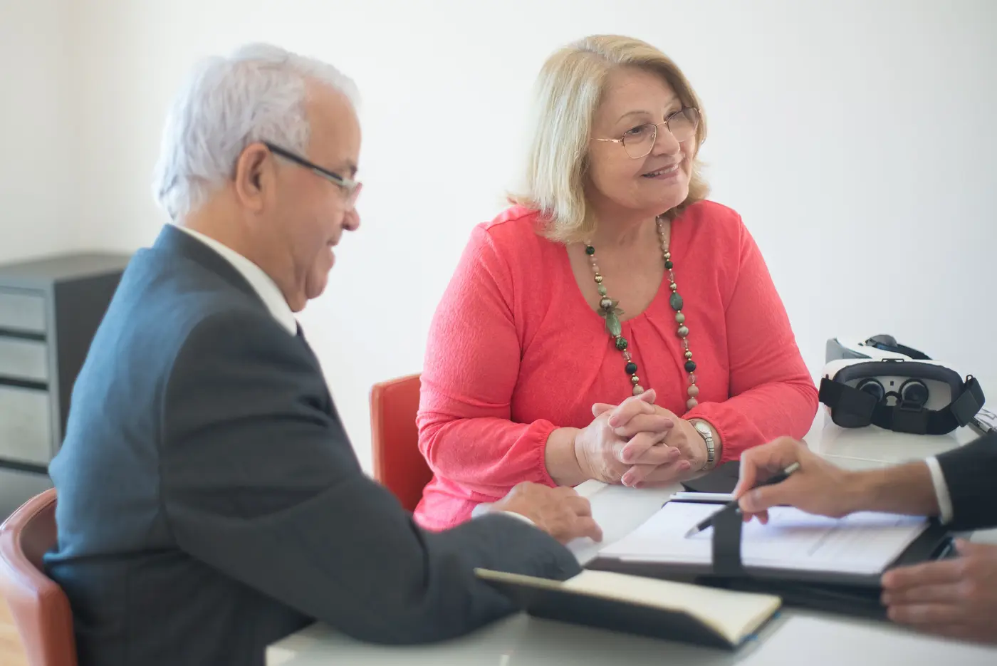 Older homeowners discussing mortgage options with a professional